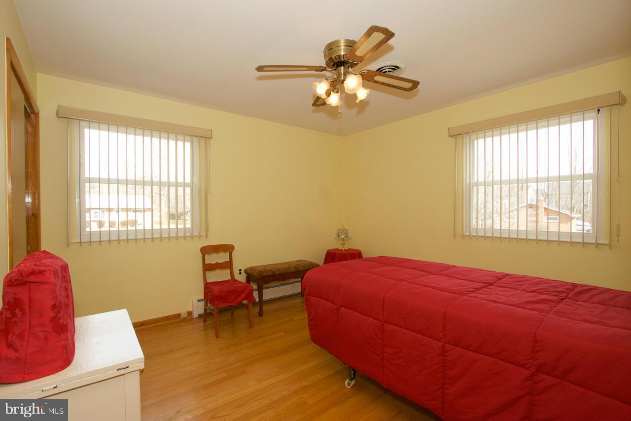 2307 Mills Road Fallston, MD 21047 - Photo 18 of 30 a bedroom with a bed and chandelier