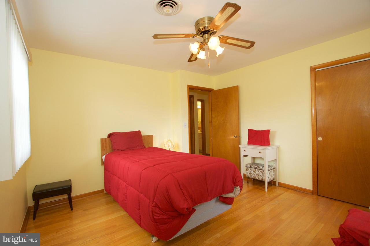 2307 Mills Road Fallston, MD 21047 - Photo 19 of 30 a bedroom with a bed and a chandelier