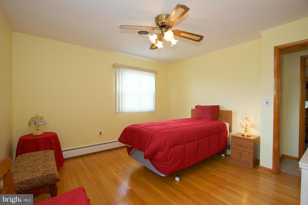 2307 Mills Road Fallston, MD 21047 - Photo 20 of 30 a bedroom with a bed and a chandelier