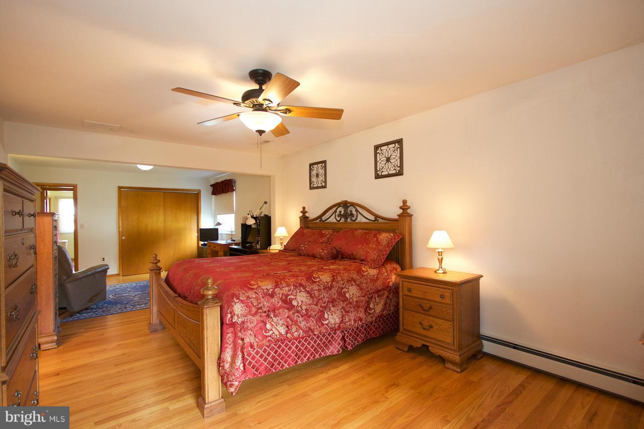 2307 Mills Road Fallston, MD 21047 - Photo 21 of 30 a bedroom with a bed and a chandelier
