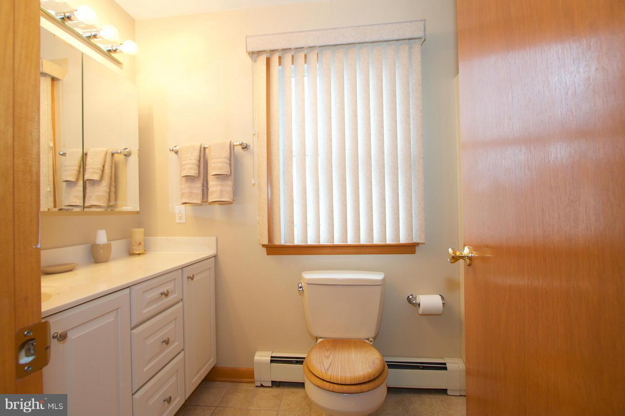 2307 Mills Road Fallston, MD 21047 - Photo 22 of 30 a bathroom with a toilet a sink and a window