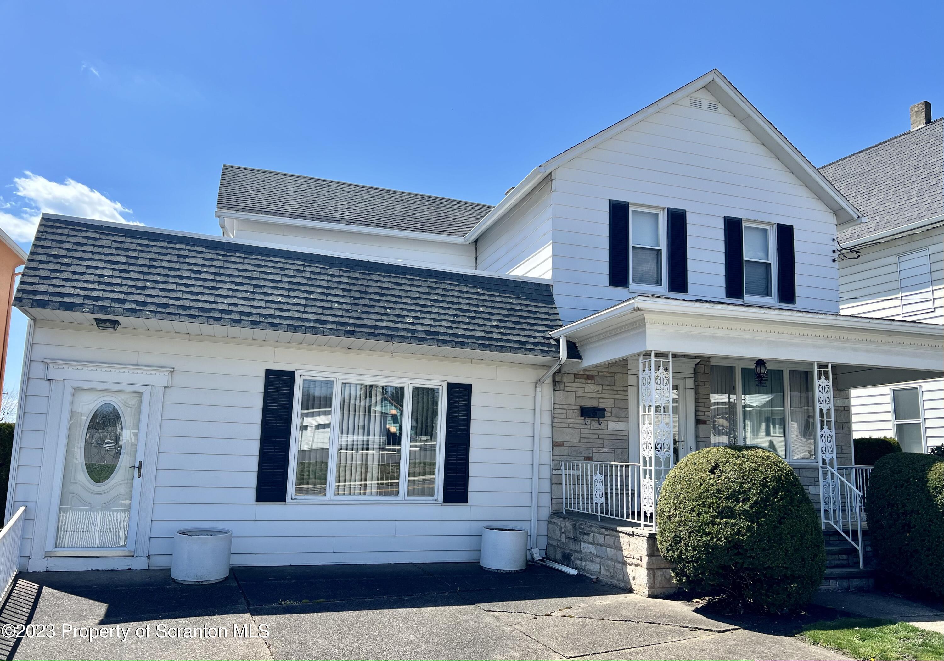 204 Moosic Road Old Forge, PA 18518 - Photo 1 of 31 a front view of a house with garden