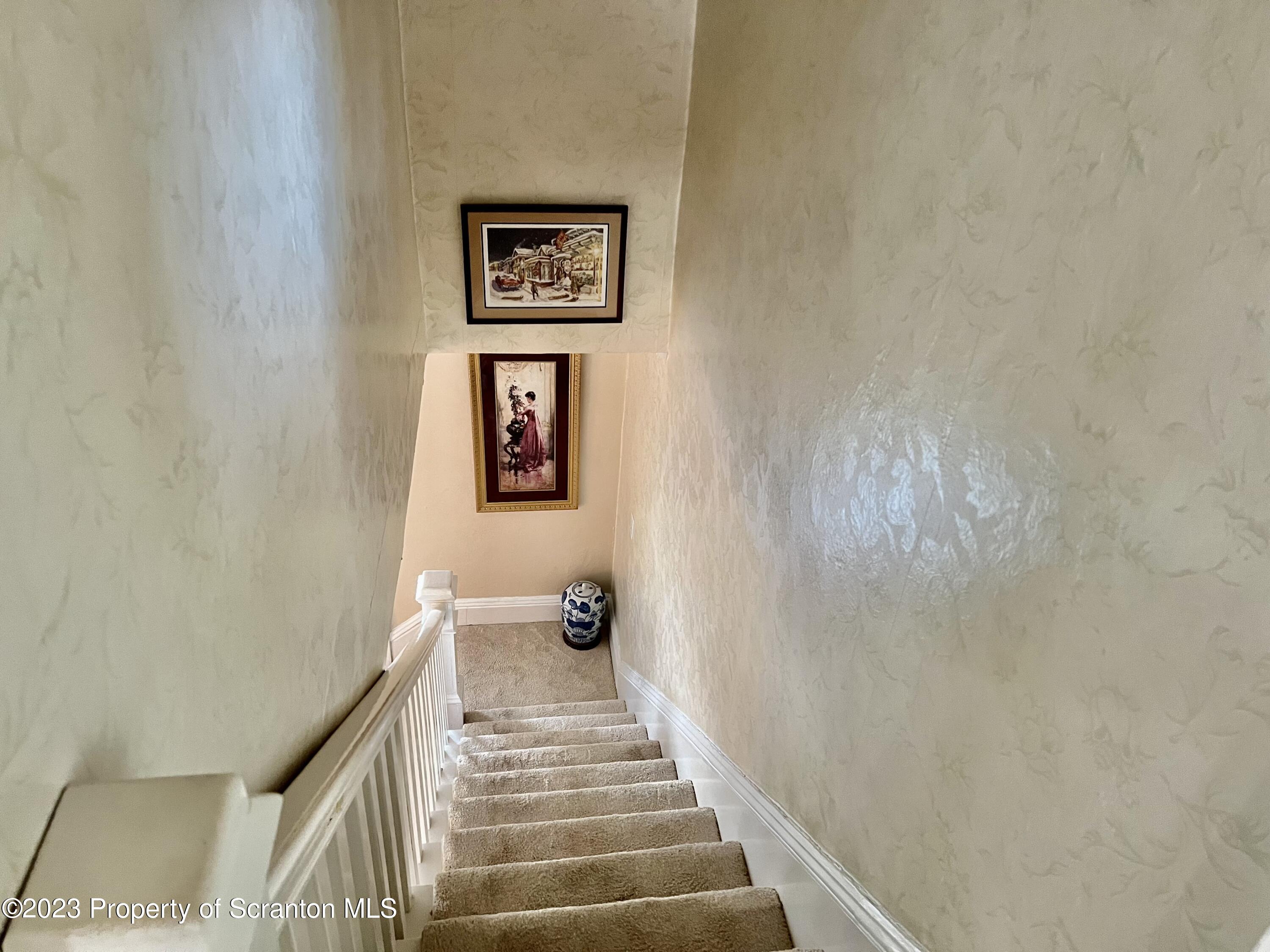 204 Moosic Road Old Forge, PA 18518 - Photo 15 of 31 a view of a hallway with wooden floor and a bathroom