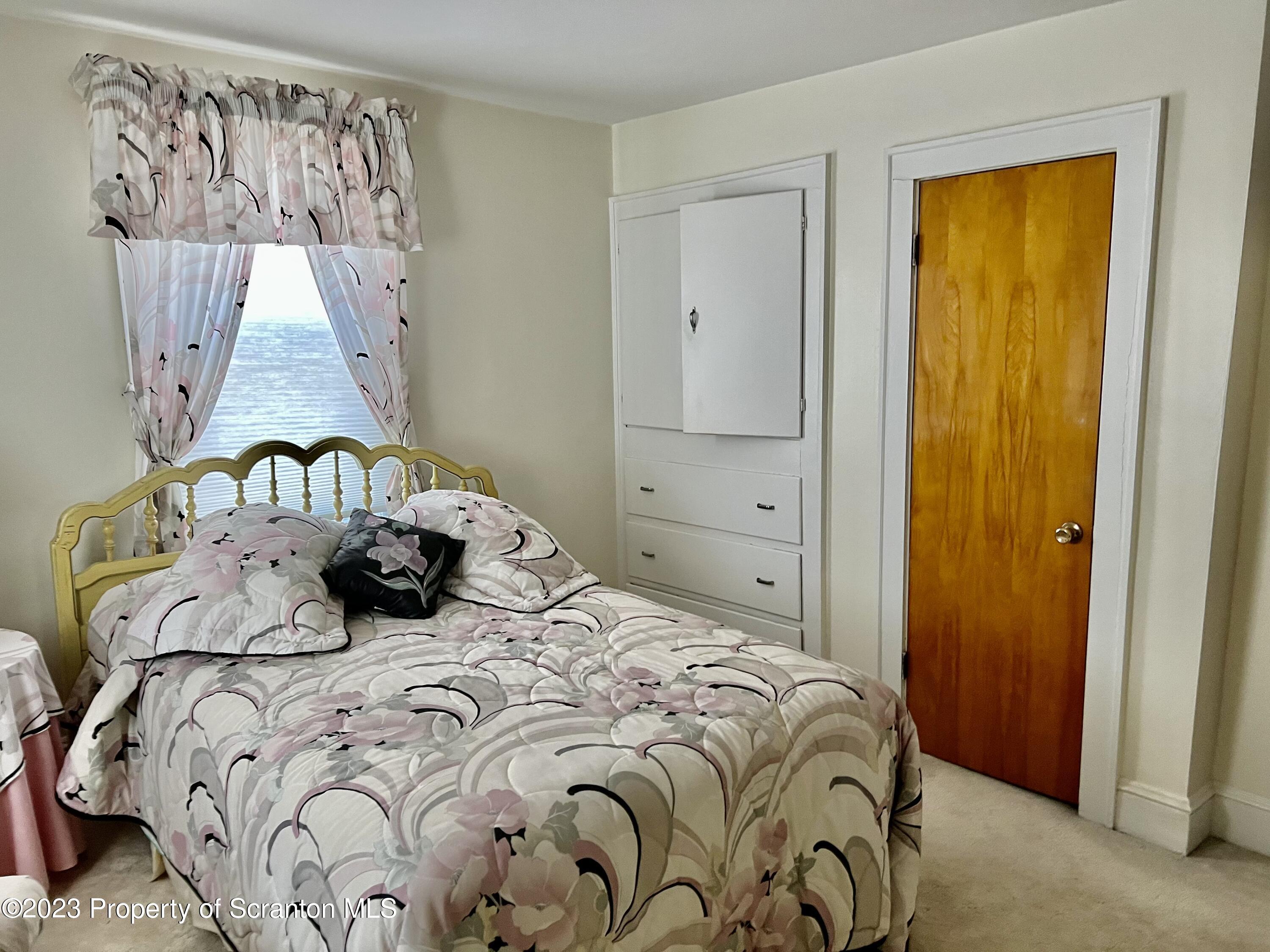 204 Moosic Road Old Forge, PA 18518 - Photo 18 of 31 a bedroom with a bed and a window in it