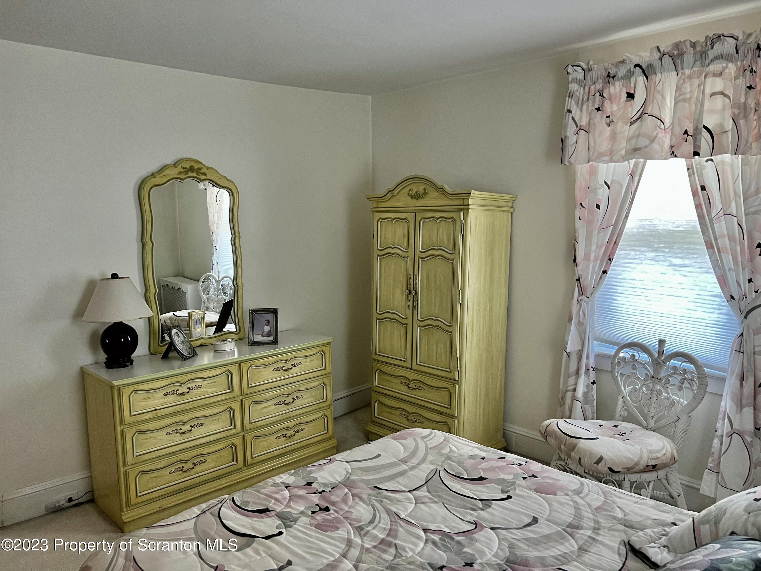 204 Moosic Road Old Forge, PA 18518 - Photo 19 of 31 a bedroom with a bed and a dresser