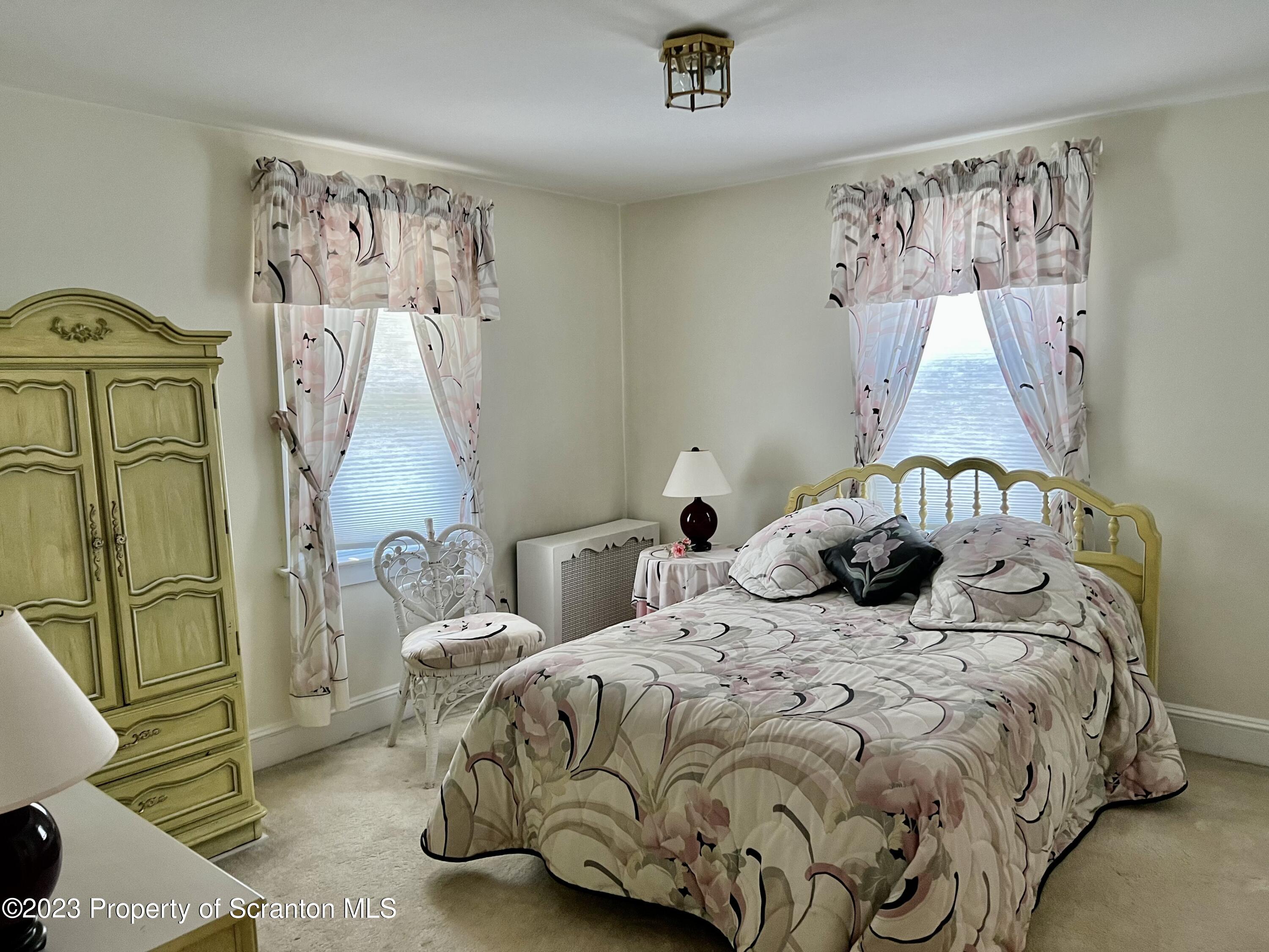 204 Moosic Road Old Forge, PA 18518 - Photo 20 of 31 a bedroom with a bed and painting on the wall