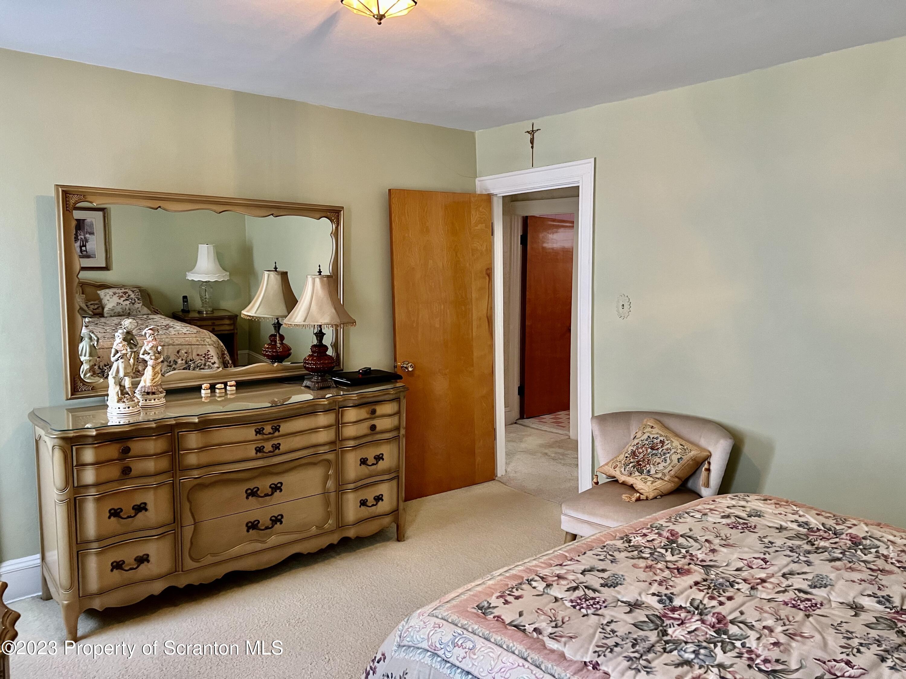 204 Moosic Road Old Forge, PA 18518 - Photo 21 of 31 a bedroom with a bed and a dresser
