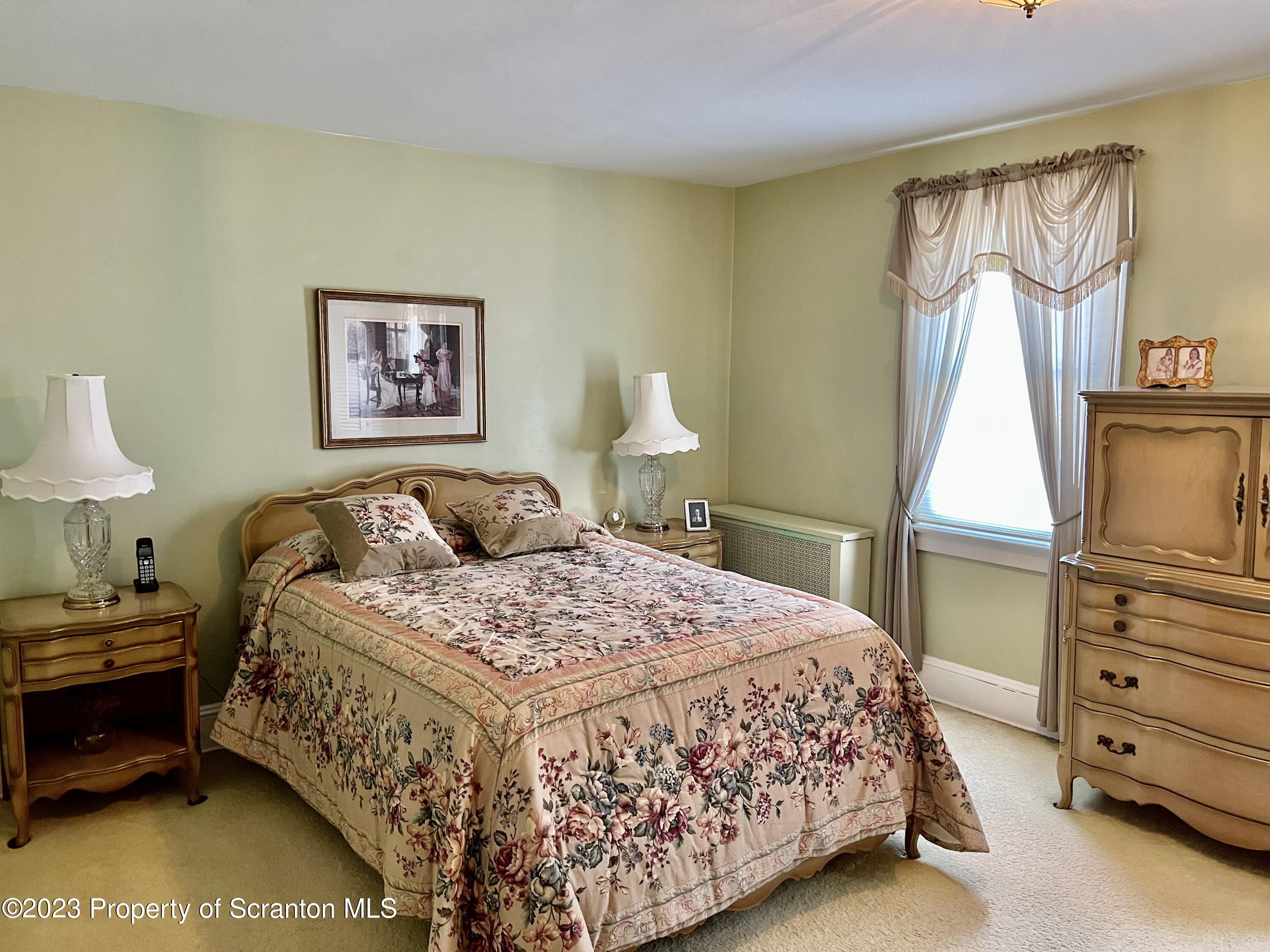 204 Moosic Road Old Forge, PA 18518 - Photo 23 of 31 a bedroom with a bed and a window