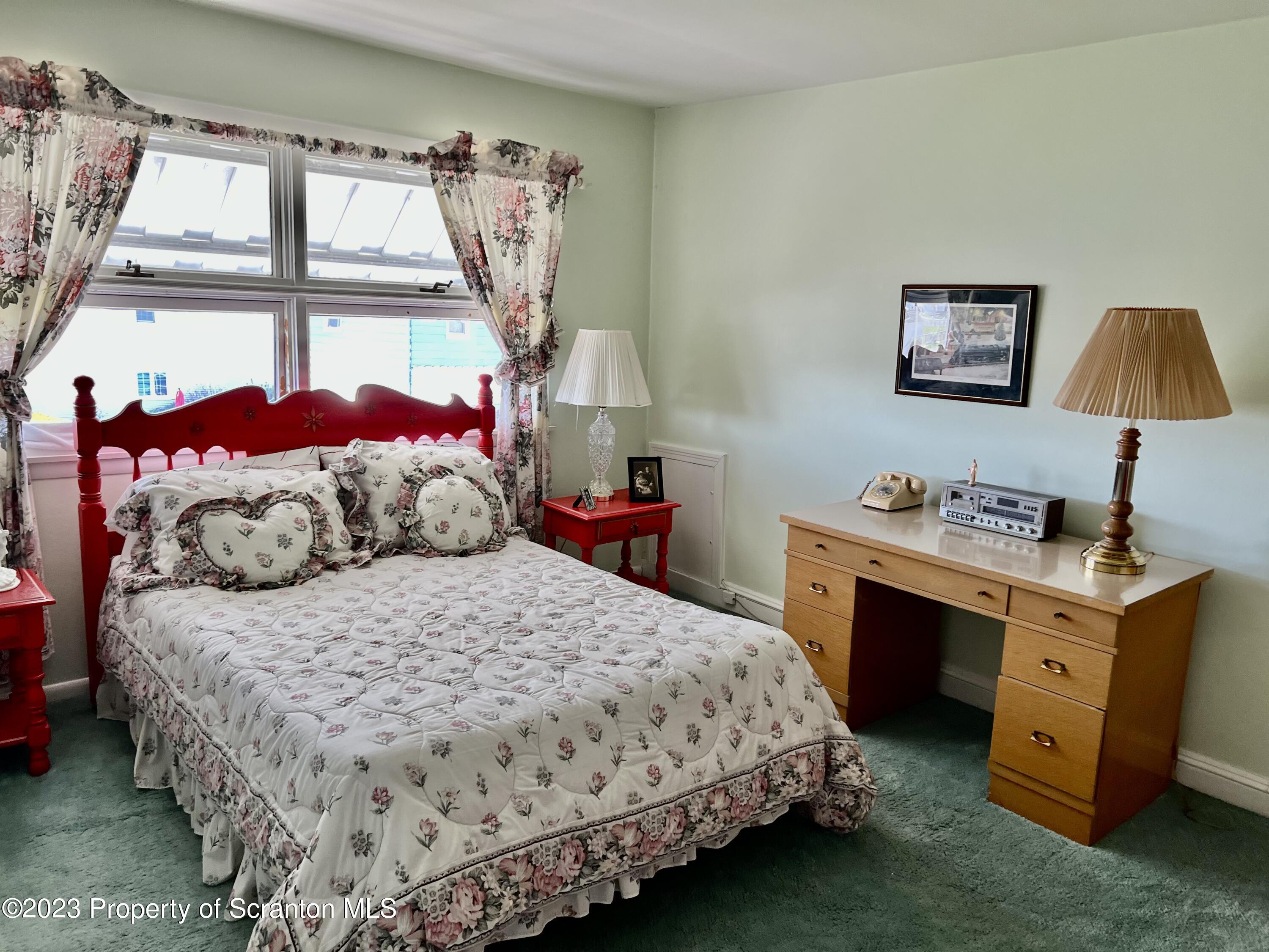 204 Moosic Road Old Forge, PA 18518 - Photo 24 of 31 a bedroom with a bed and a window