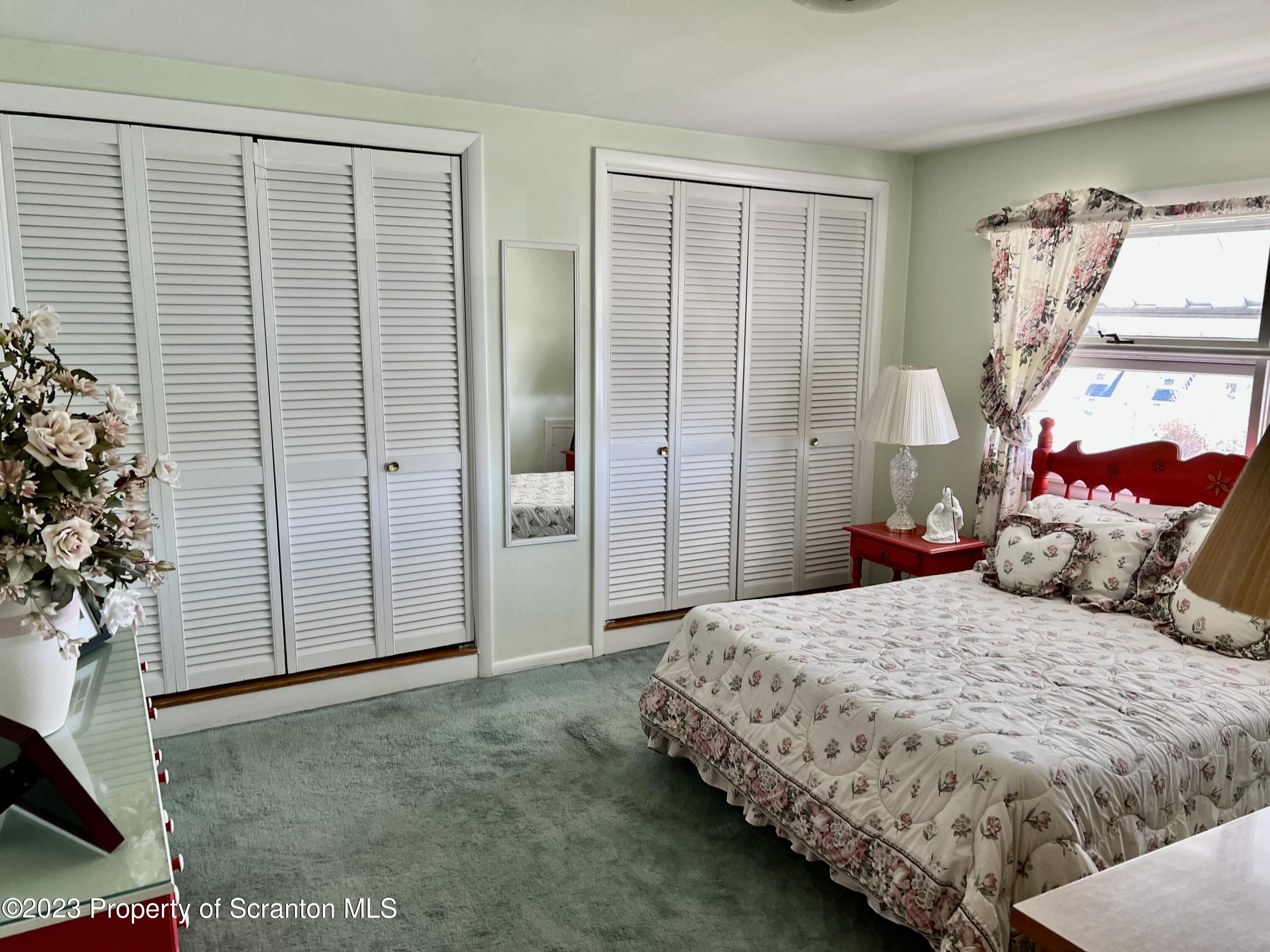 204 Moosic Road Old Forge, PA 18518 - Photo 25 of 31 a bedroom with a large bed and a potted plant