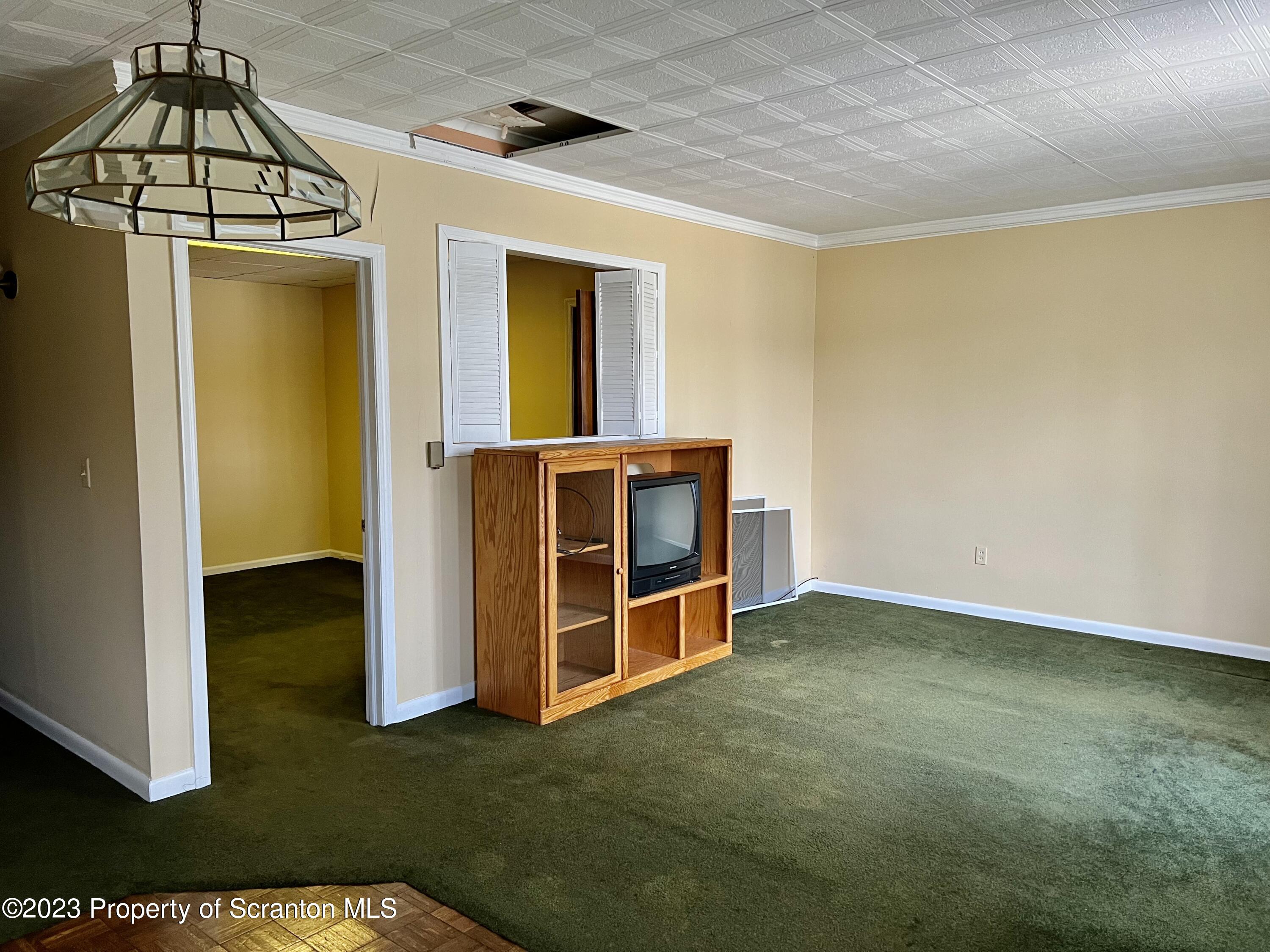204 Moosic Road Old Forge, PA 18518 - Photo 27 of 31 a view of an empty room with wooden floor and a window