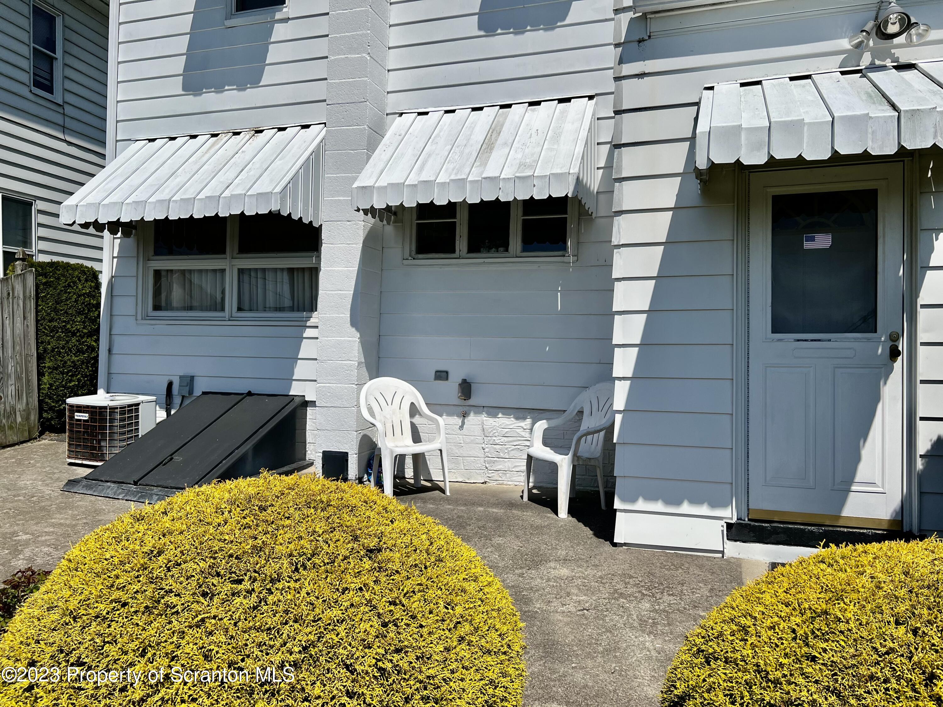 204 Moosic Road Old Forge, PA 18518 - Photo 3 of 31 a front view of a house with garden