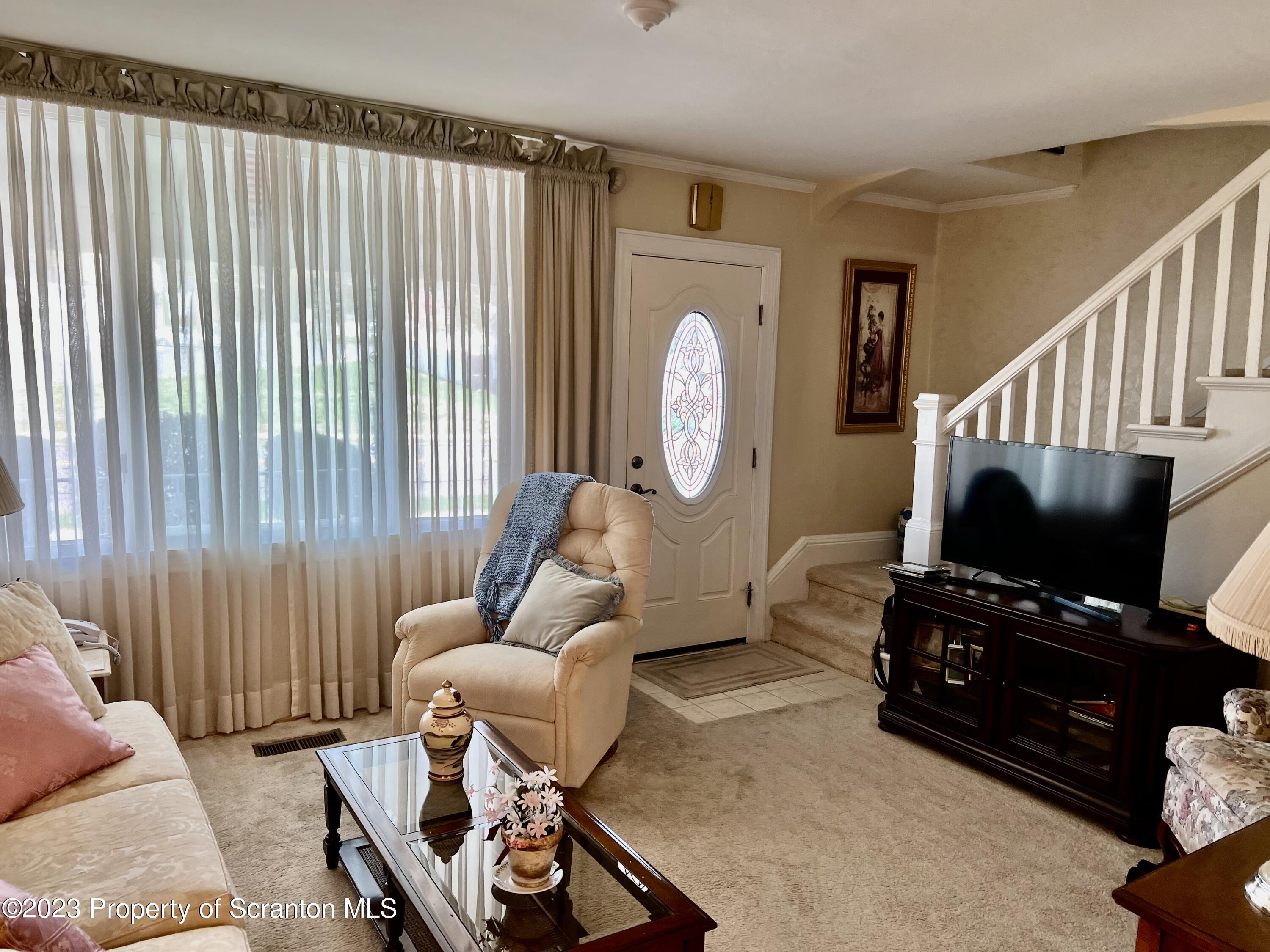 204 Moosic Road Old Forge, PA 18518 - Photo 6 of 31 a living room with furniture a flat screen tv and a window