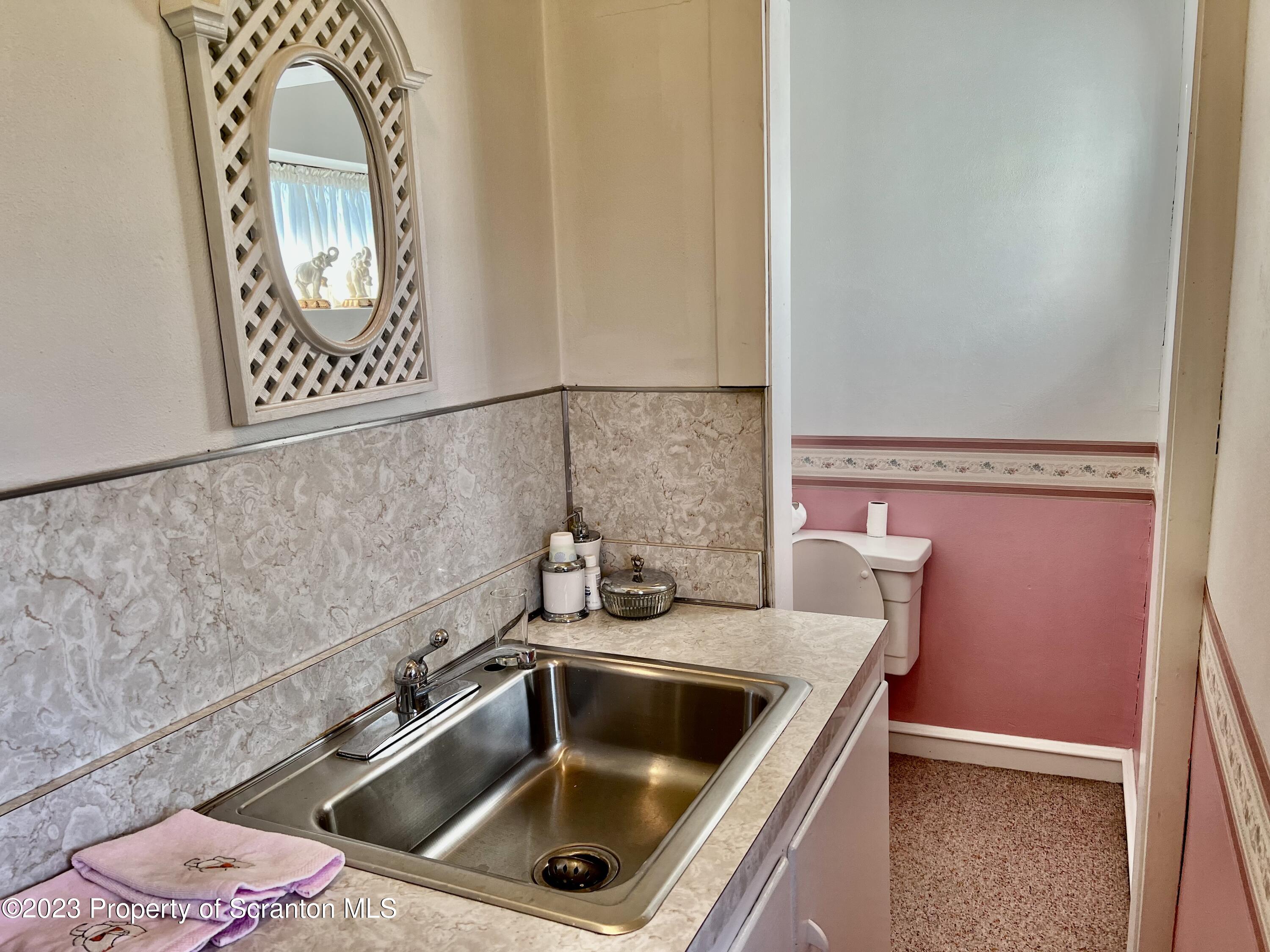 204 Moosic Road Old Forge, PA 18518 - Photo 10 of 31 a bathroom with a sink and a mirror