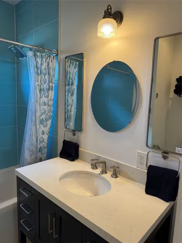 a bathroom with a sink vanity and a mirror