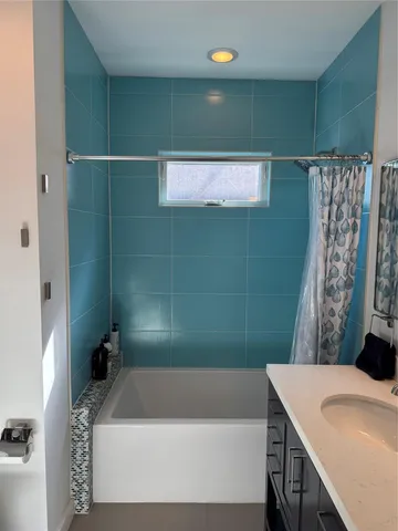 a bathroom with a bathtub and shower