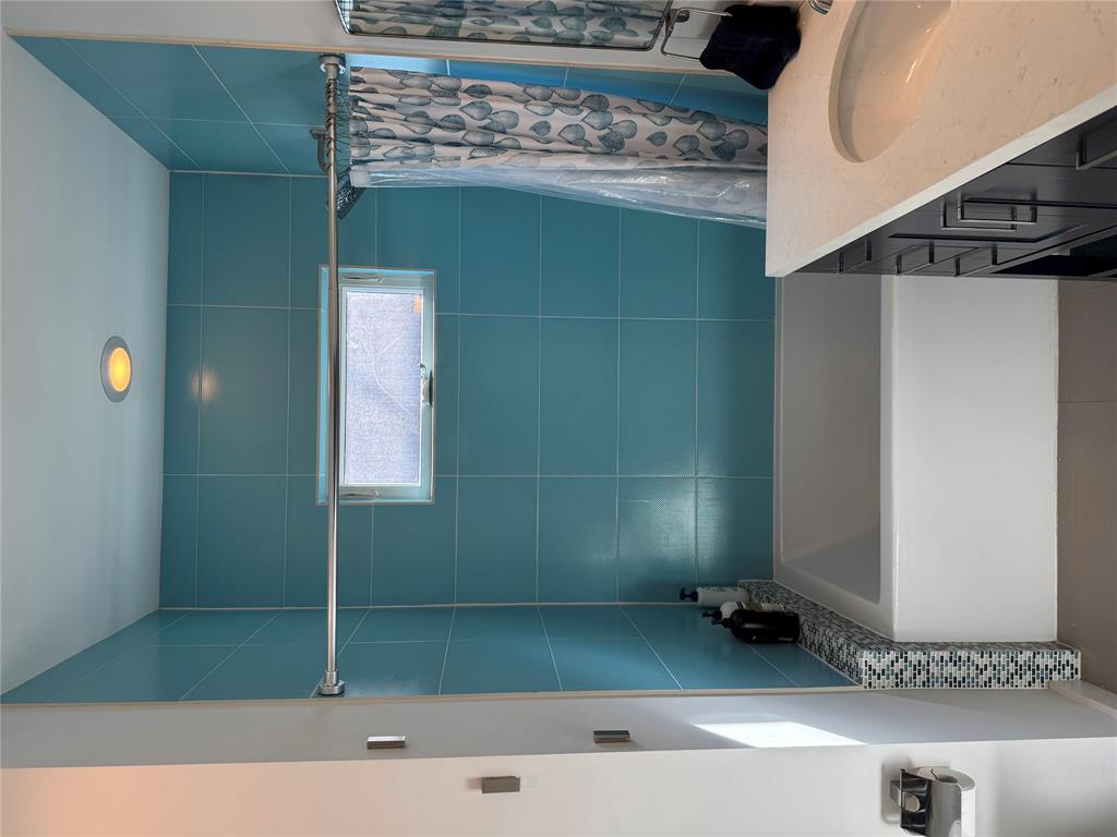 2109 Riverview Street, Unit A Austin, TX 78702 - Photo 15 of 32 a bathroom with a bathtub and shower