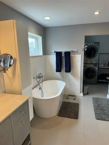 a spacious bathroom with a double vanity sink and a bathtub