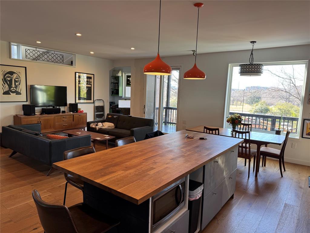 2109 Riverview Street, Unit A Austin, TX 78702 - Photo 3 of 32 a dining table chairs wooden floor and a chandelier
