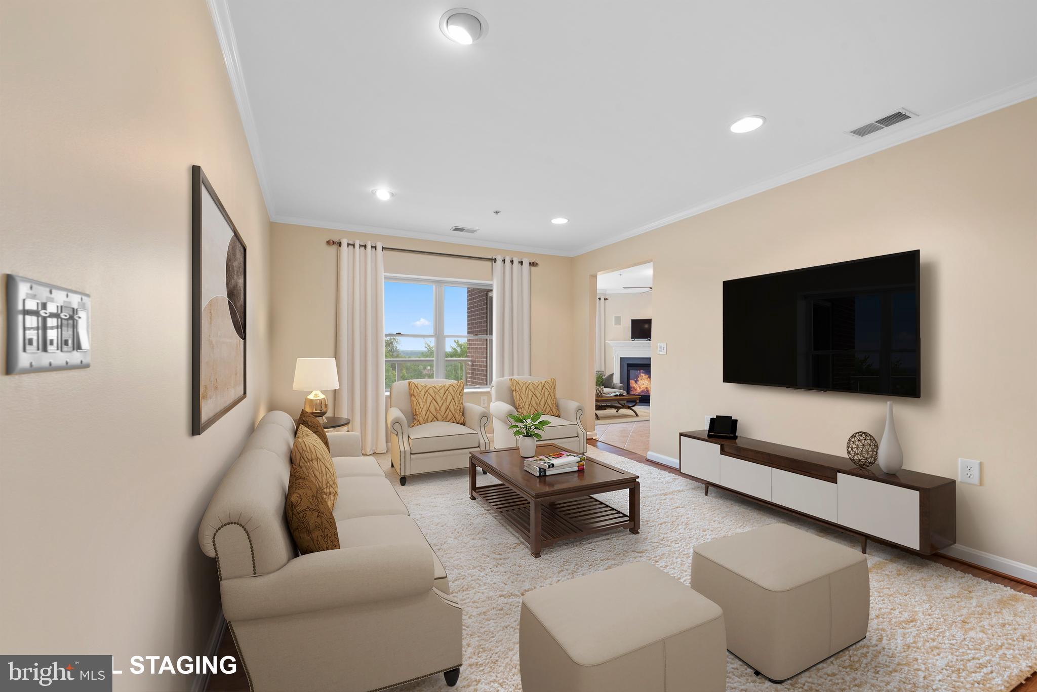 12240 Roundwood Road, Unit 704 Lutherville-Timonium, MD 21093 - Photo 5 of 22 a living room with furniture and a flat screen tv