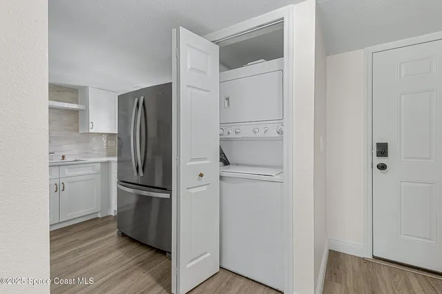 a kitchen with stainless steel appliances a stove microwave and refrigerator