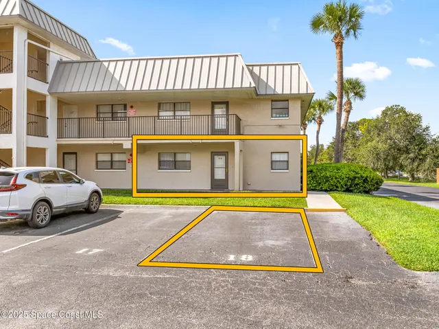 a front view of a house with a garden and plants