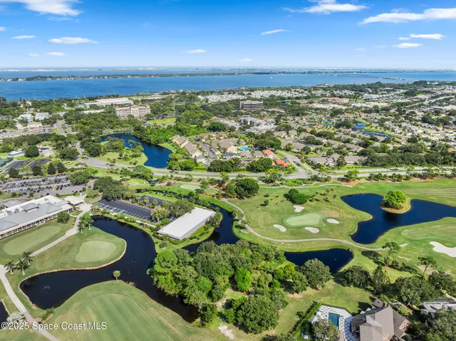 an aerial view of a house with a garden and mountain view