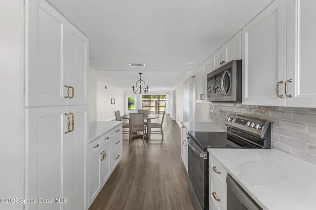 a kitchen with a refrigerator and a sink