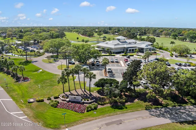 an aerial view of a house with a garden and swimming pool