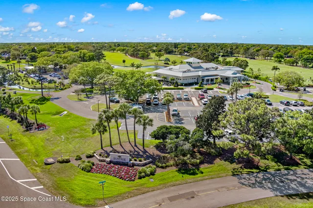 an aerial view of residential houses with outdoor space and swimming pool