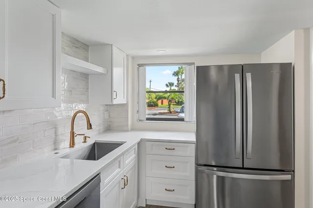 a kitchen with a sink stove and microwave