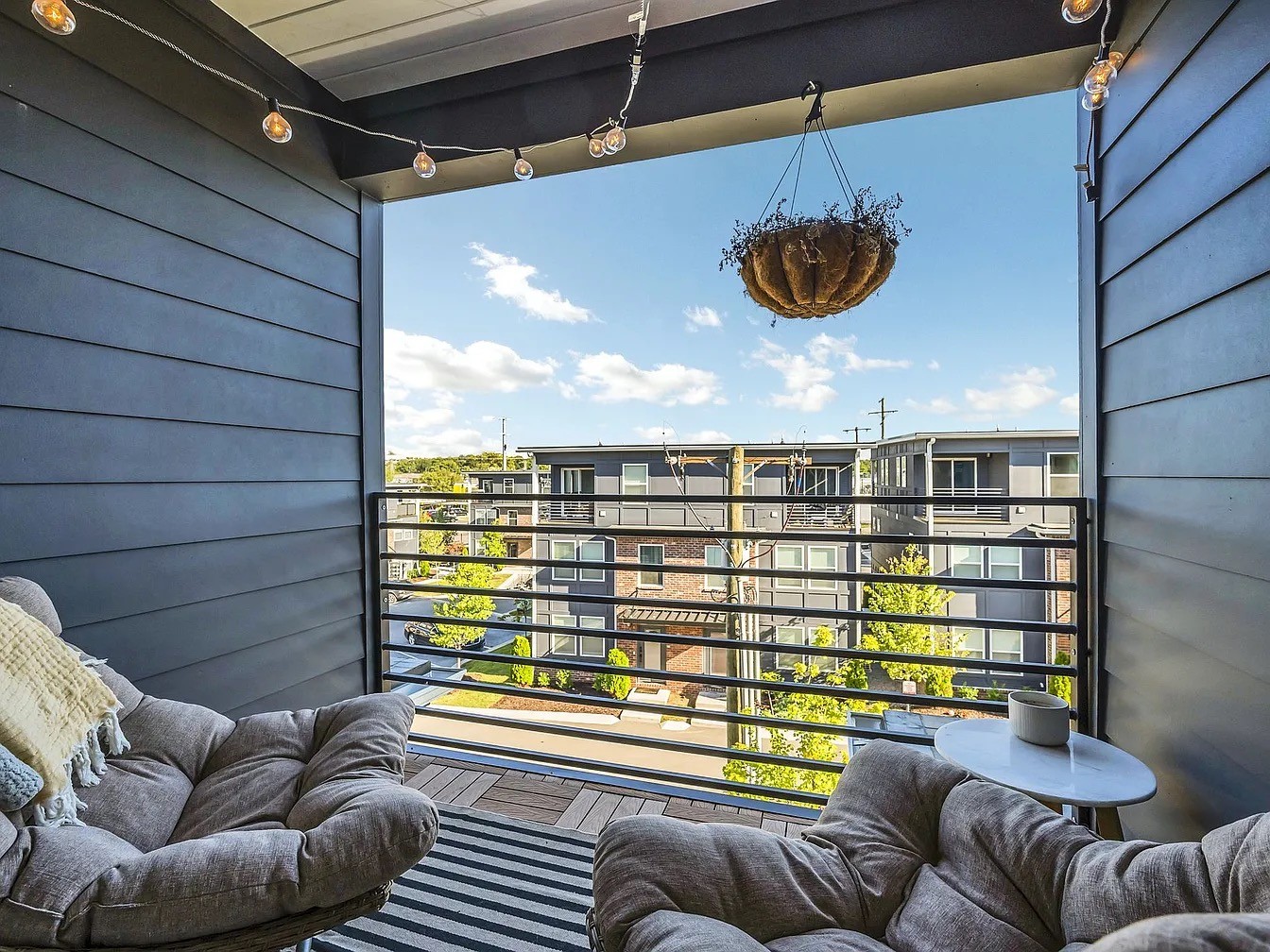 102 Duke Street, Unit 33 Nashville, TN 37207 - Photo 5 of 15 a view of a balcony with couches and potted plants