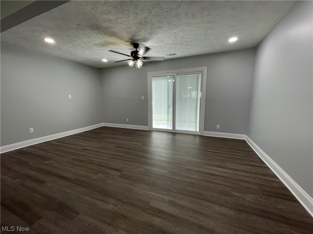 1857 Sterling Road Madison, OH 44057 - Photo 8 of 33 Wood floored spare room with a textured ceiling and ceiling fan
