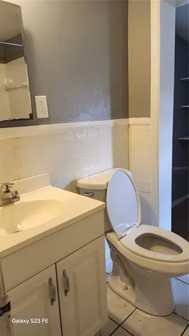 a white toilet sitting next to a bathroom sink