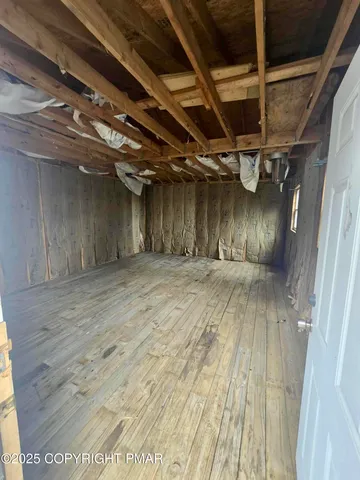 a view of a house with a yard and a wooden bench