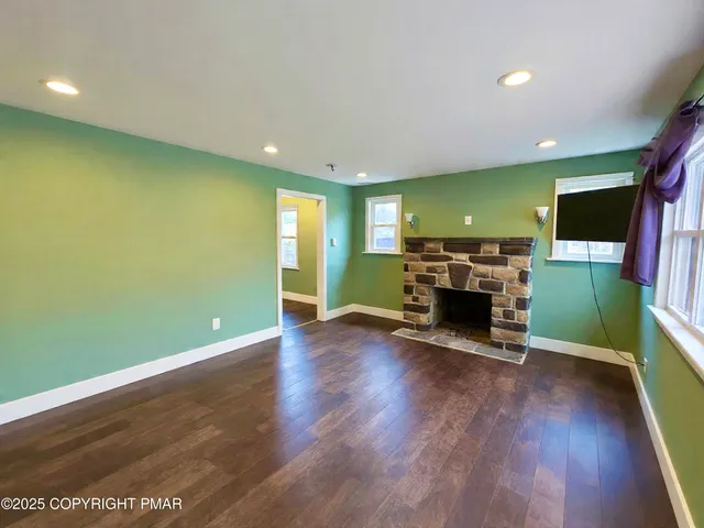 a kitchen with stainless steel appliances granite countertop a stove top oven a sink dishwasher and a refrigerator