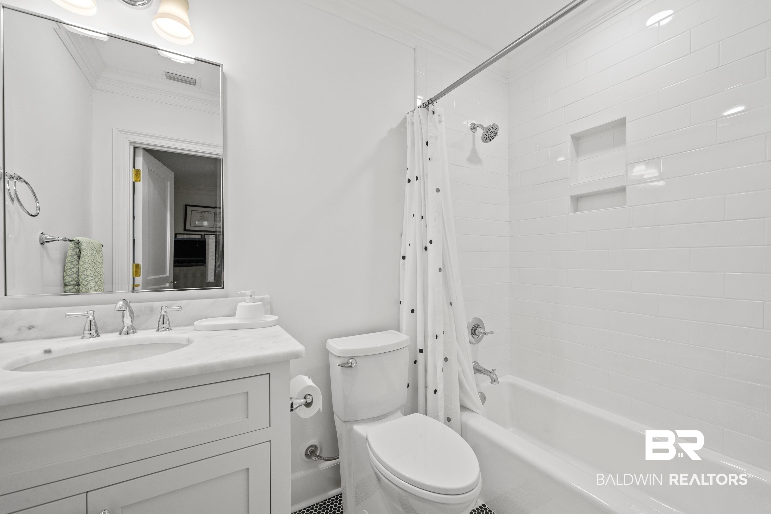141 Myrtlewood Lane Mobile, AL 36608 - Photo 29 of 44 Bathroom featuring visible vents, crown molding, toilet, vanity, and shower / bath combination with curtain
