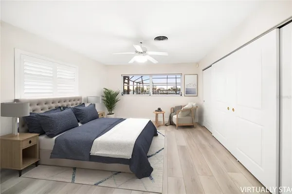 a bedroom with a bed and wooden floor