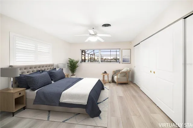 a bedroom with a bed couch and window