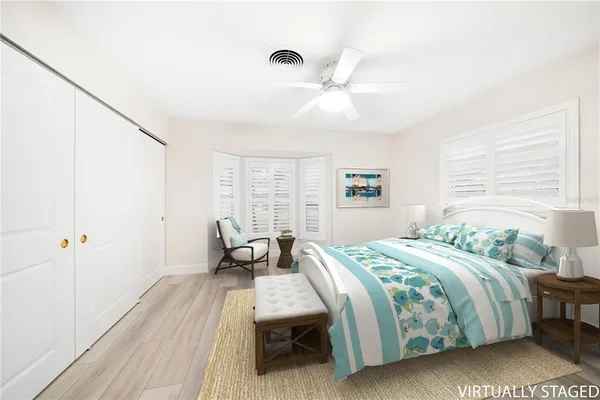 a bathroom with a granite countertop sink toilet and mirror