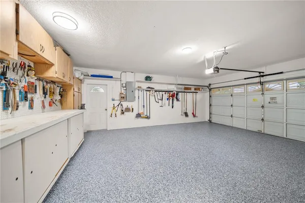 a sign that is sitting in front of flowers