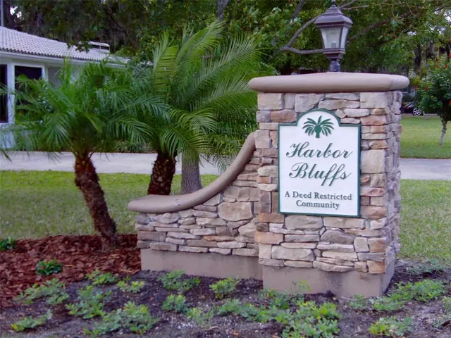 a sign that is sitting in front of flowers