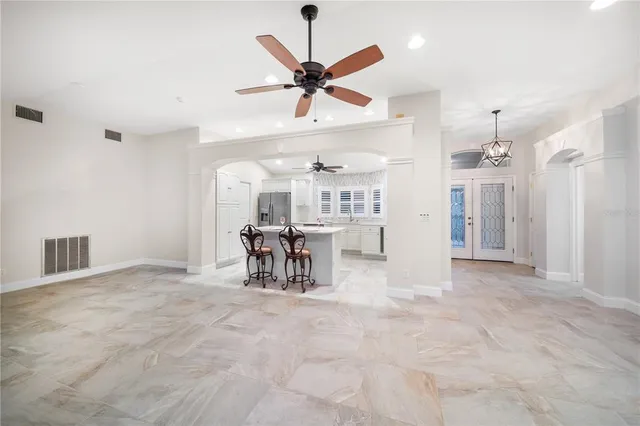 a view of a livingroom with furniture and a ceiling fan