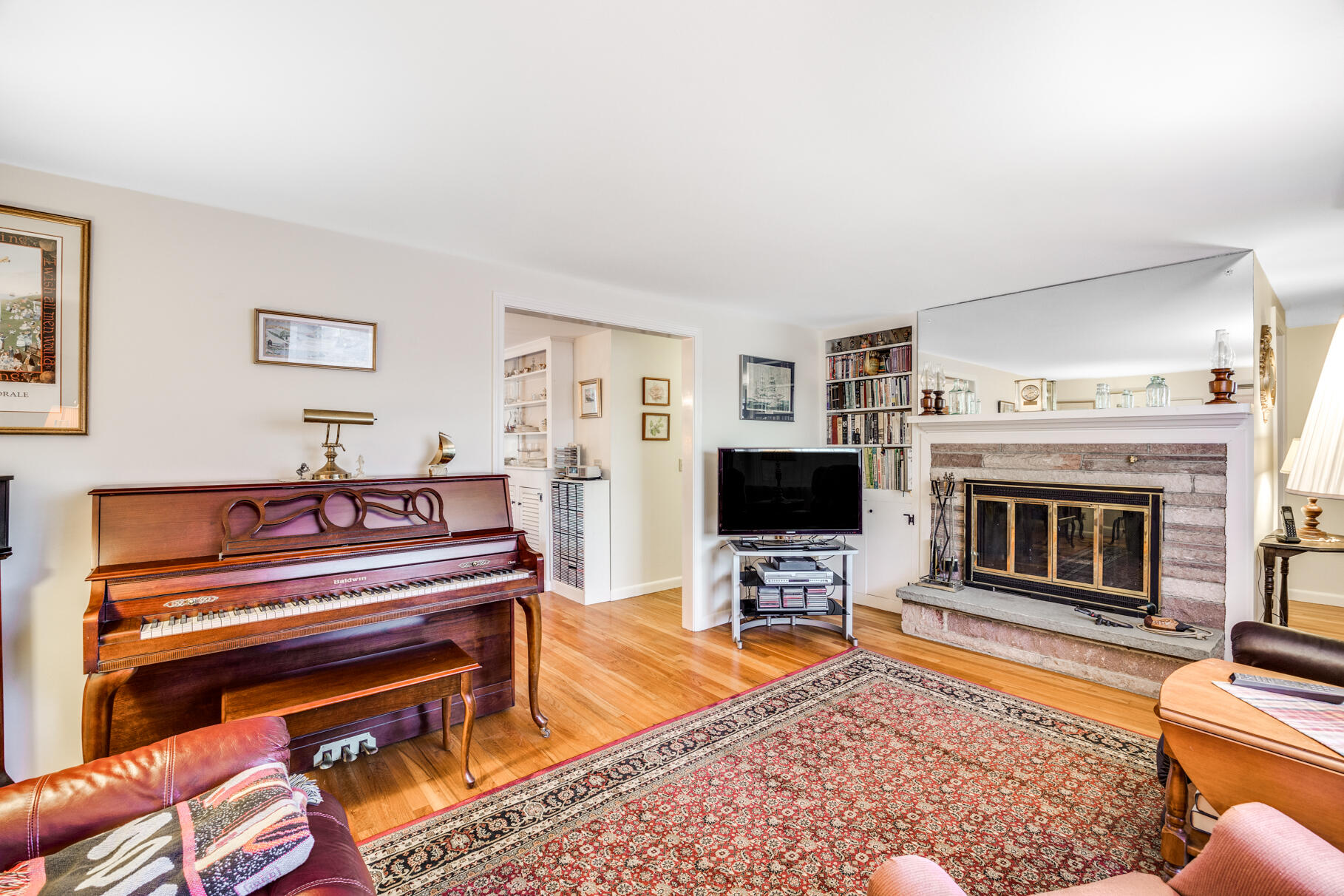 38 Rainbow Way Harwich, MA 02645 - Photo 22 of 50 a living room with furniture a flat screen tv and a fireplace
