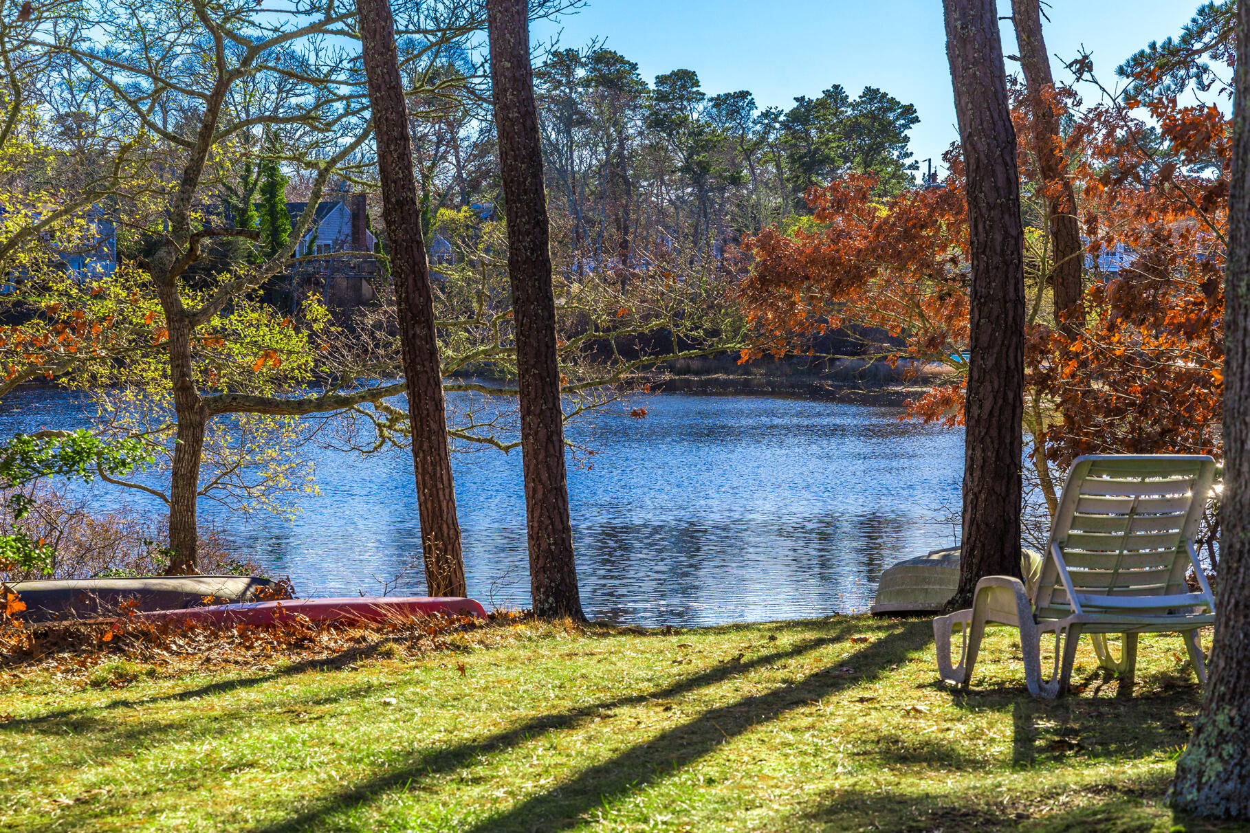 38 Rainbow Way Harwich, MA 02645 - Photo 42 of 50 a view of swimming pool with lawn chairs and wooden fence