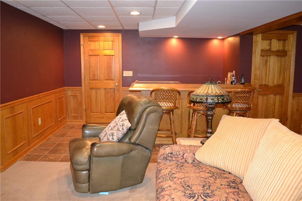 5808 Claridge Road Murrysville, PA 15632 - Photo 18 of 25 Second view of finished game room with wet bar, ceramic flooring and access to huge laundry/storage area.