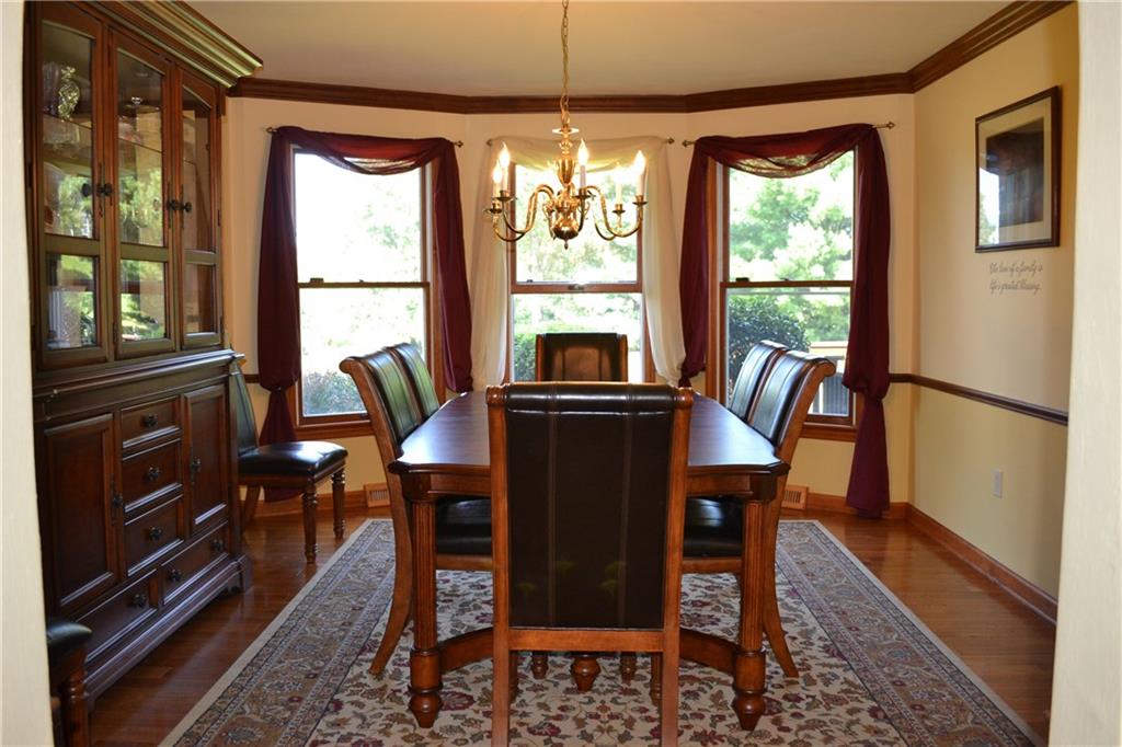 5808 Claridge Road Murrysville, PA 15632 - Photo 3 of 25 Formal dining room with walk in bay, crown molding, chair rail and hardwood flooring.