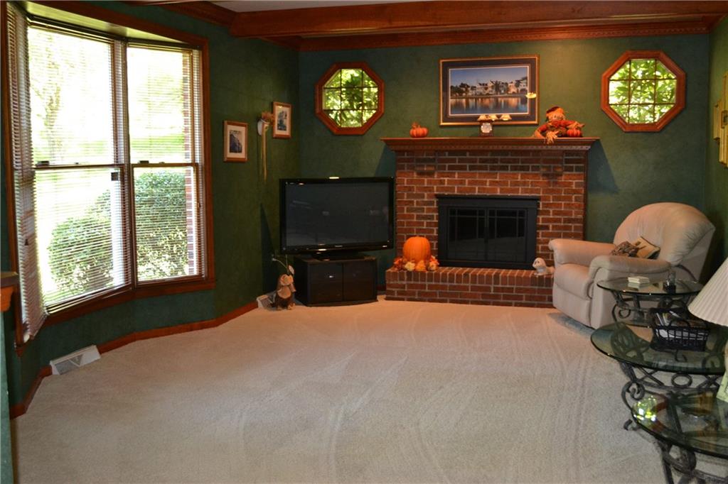 5808 Claridge Road Murrysville, PA 15632 - Photo 6 of 25 Spacious sunken family room featuring walk-in bay, gas log fireplace, crown molding and beamed ceiling.