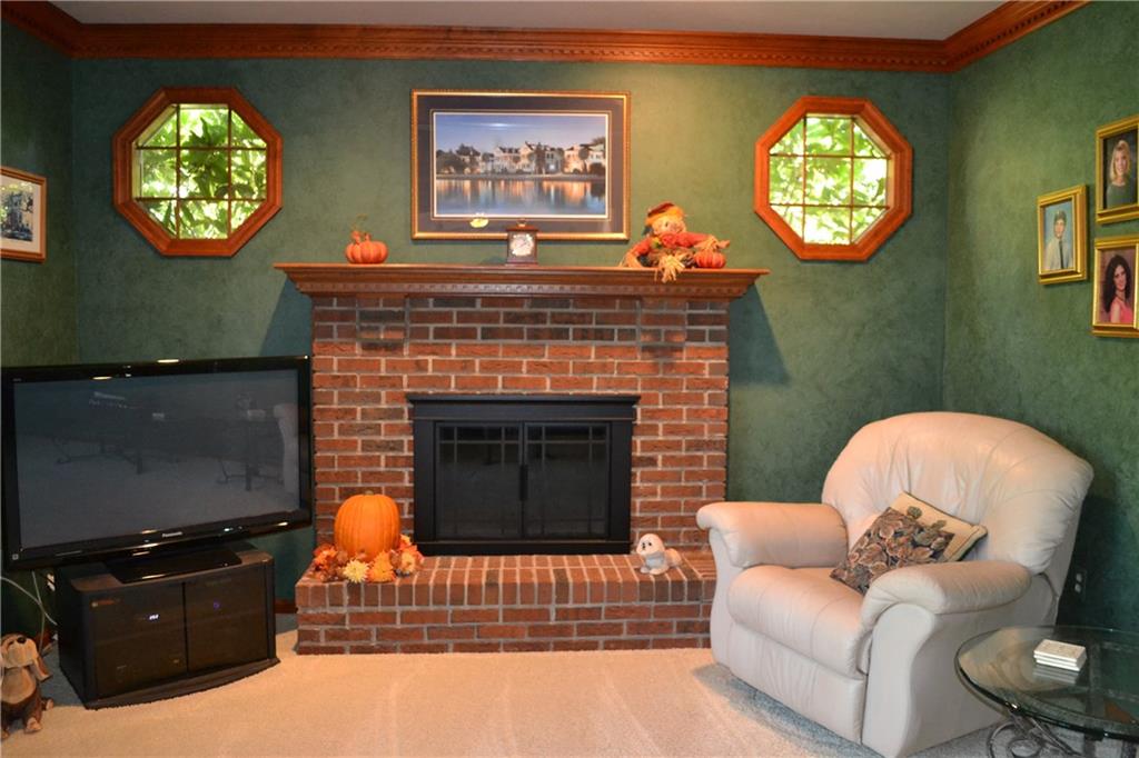 5808 Claridge Road Murrysville, PA 15632 - Photo 7 of 25 Gas log fireplace and circle windows give plenty of additional lighting for family room.