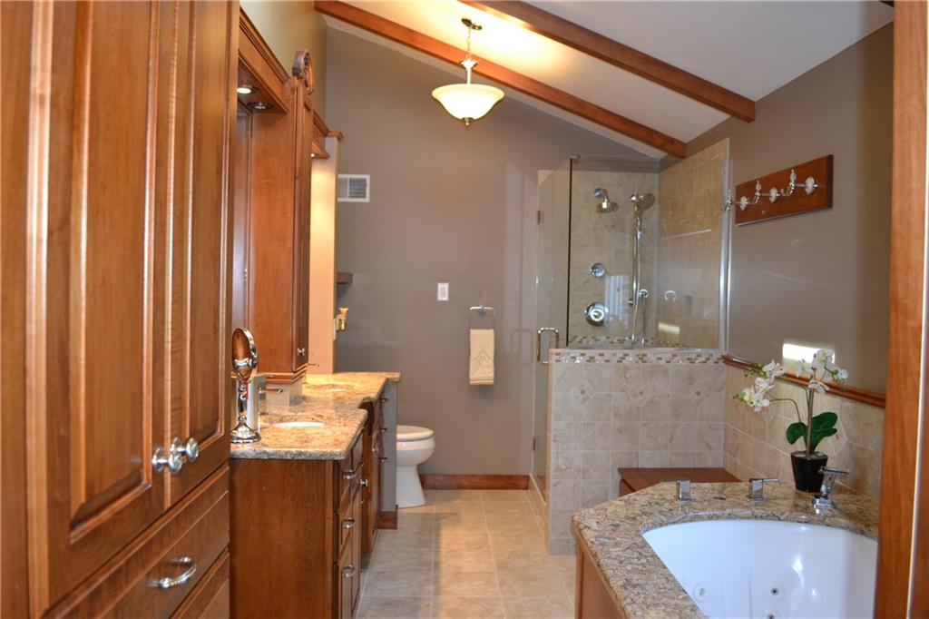 5808 Claridge Road Murrysville, PA 15632 - Photo 10 of 25 Totally remodeled master bath with granite counters, ceramic & glass shower, whirlpool tub, vaulted ceiling, ceramic flooring.